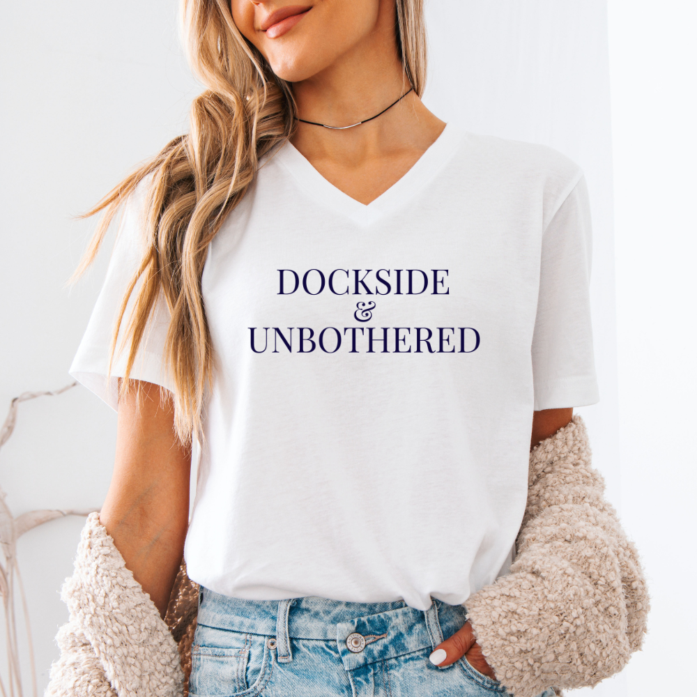 Person wearing a white t-shirt with 'Dockside & Unbothered' text against a light background