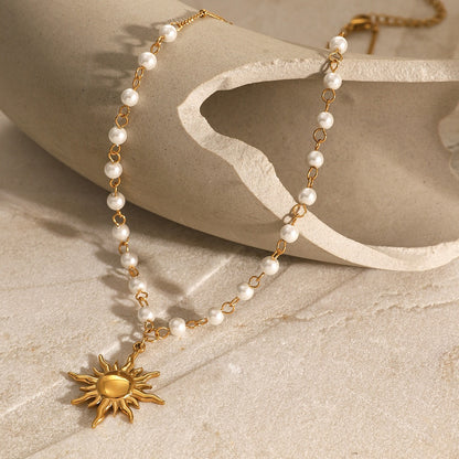 Elegant pearl necklace with sun pendant