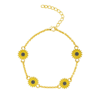 Gold bracelet with sunflower designs on a white background