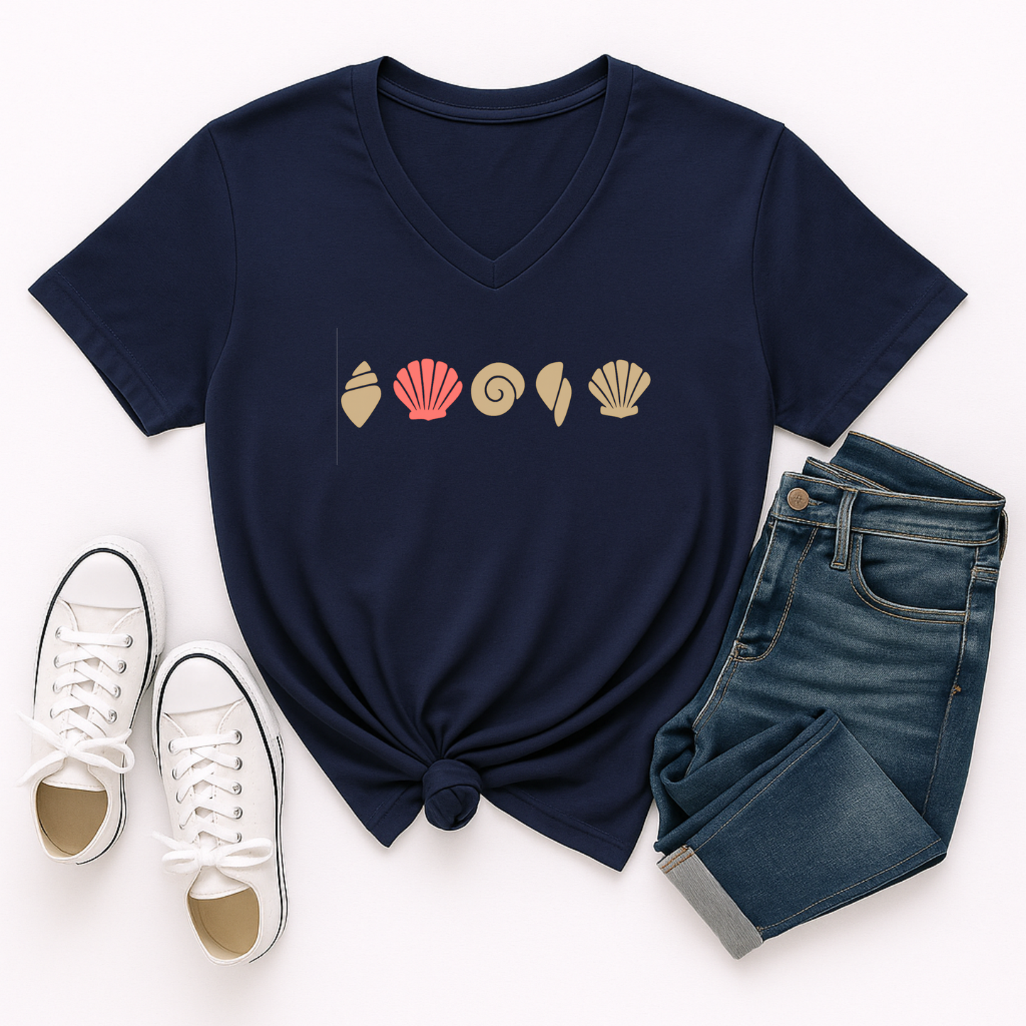 Navy blue t-shirt with shell design, white sneakers, and blue jeans on a white background