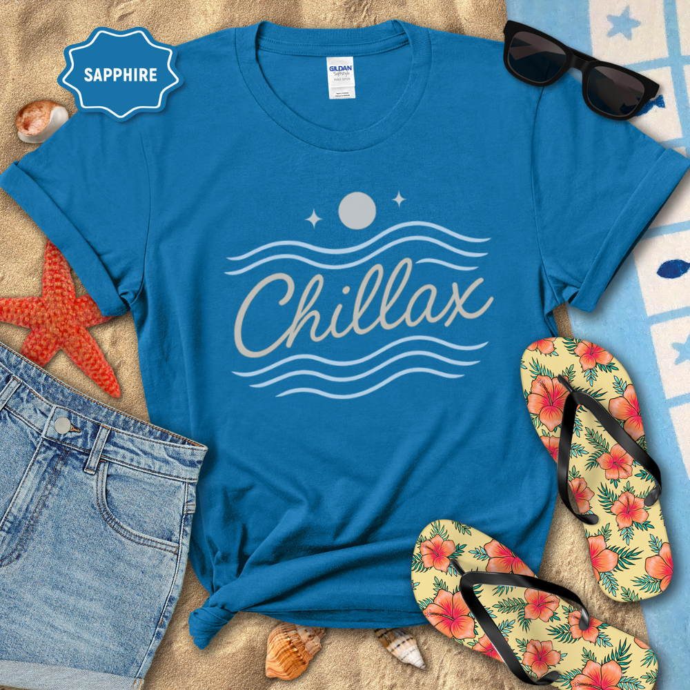 Blue t-shirt with 'Chillax' design on a beach setting with sunglasses, flip-flops, and denim shorts.
