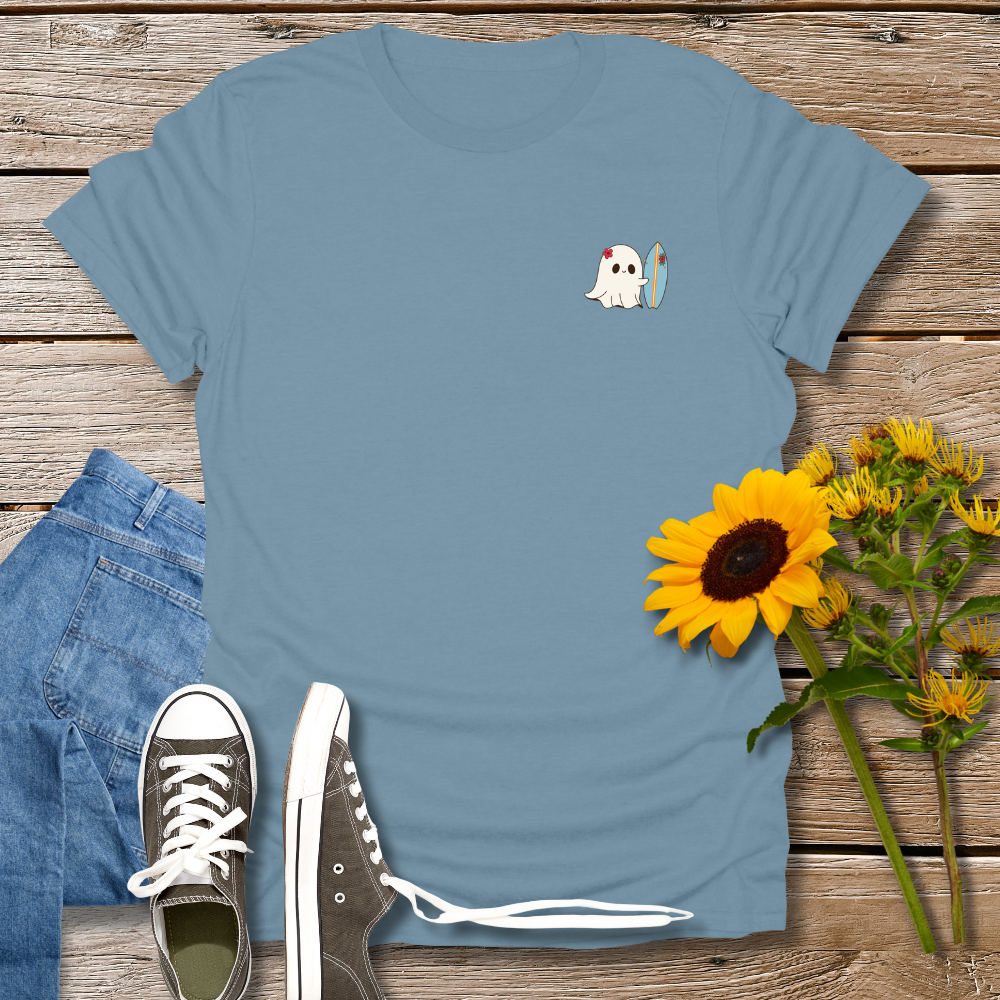 Blue t-shirt with a ghost graphic, jeans, sneakers, and sunflowers on a wooden surface