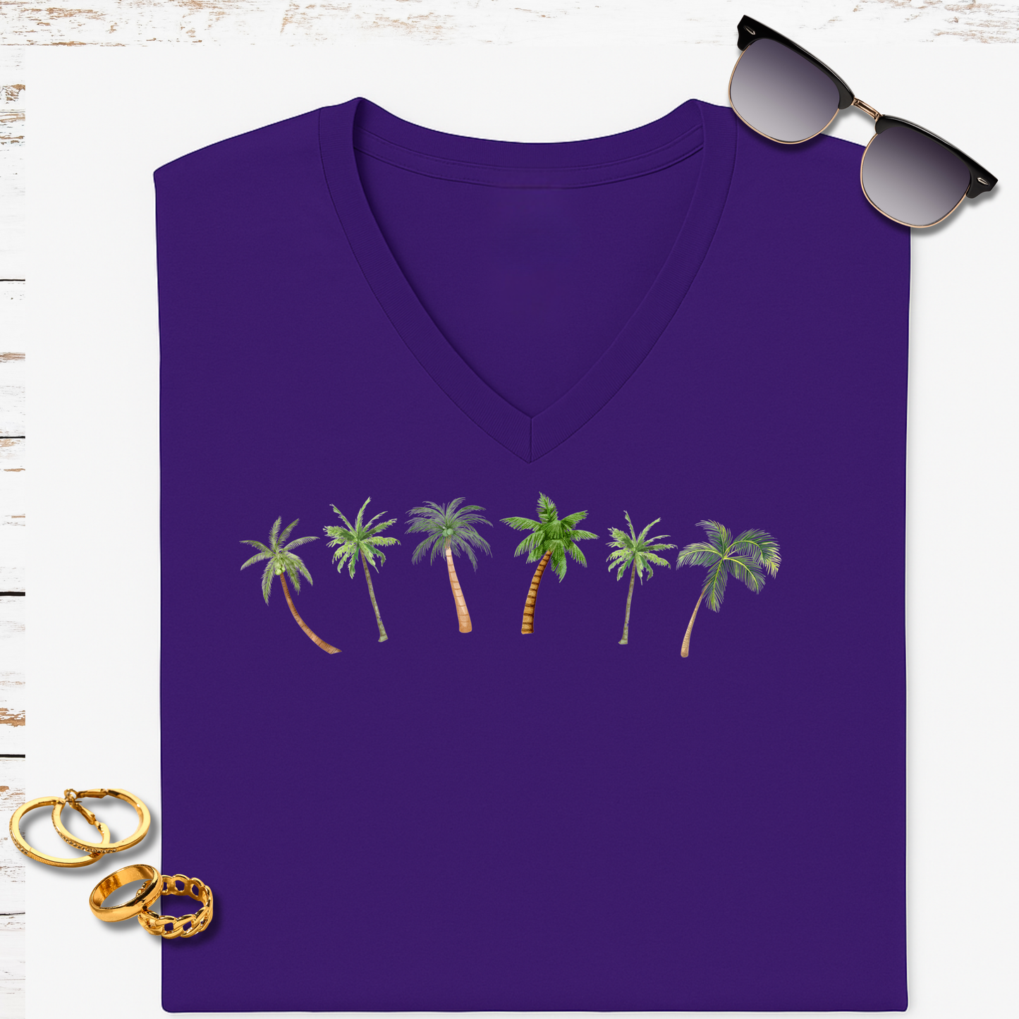 Purple V-neck t-shirt with palm tree design on a white background