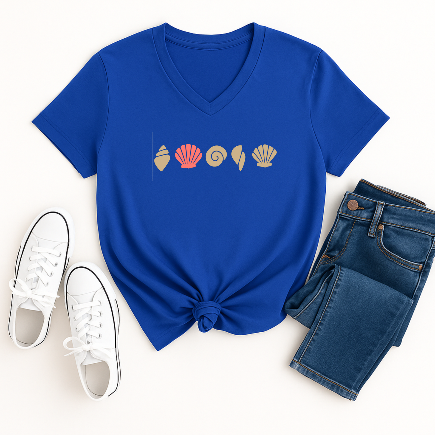 Blue t-shirt with shell design, white sneakers, and blue jeans on a white background