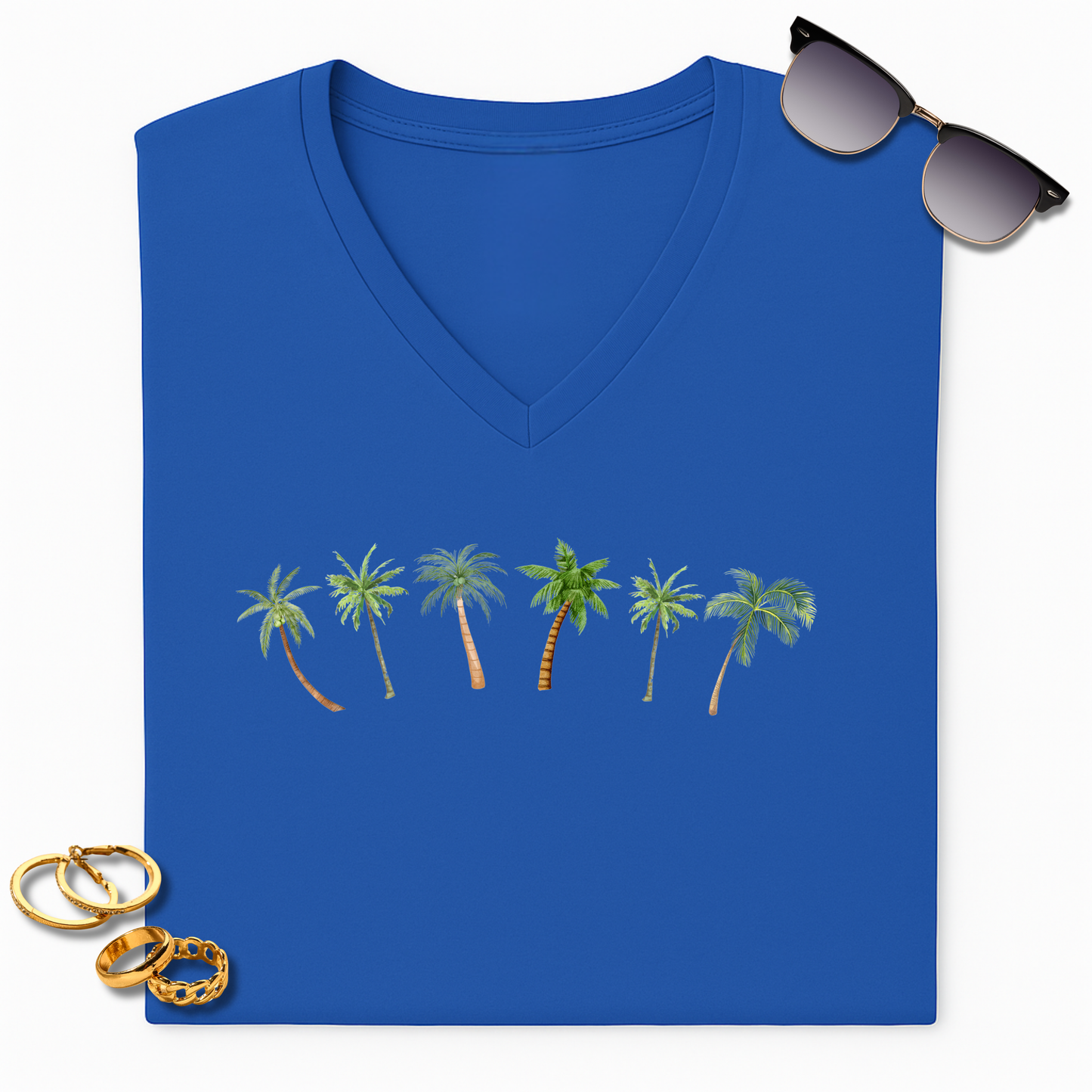 Blue V-neck t-shirt with palm tree design, sunglasses, and gold rings on a white background