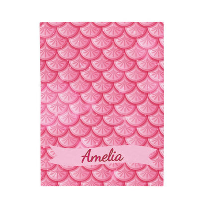 Notebook with pink fish scale pattern and 'Amelia' on a white background