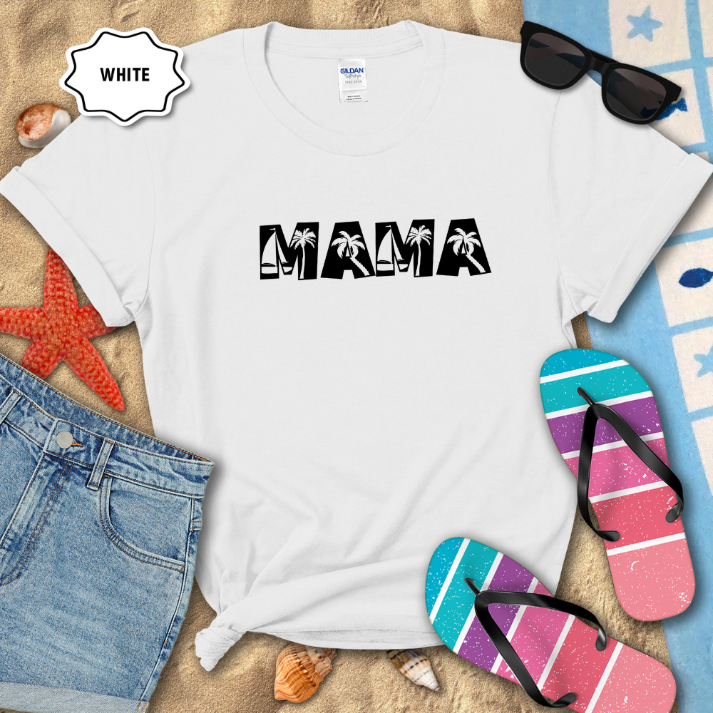 White t-shirt with 'MAMA' print on a sandy surface with flip-flops and sunglasses.