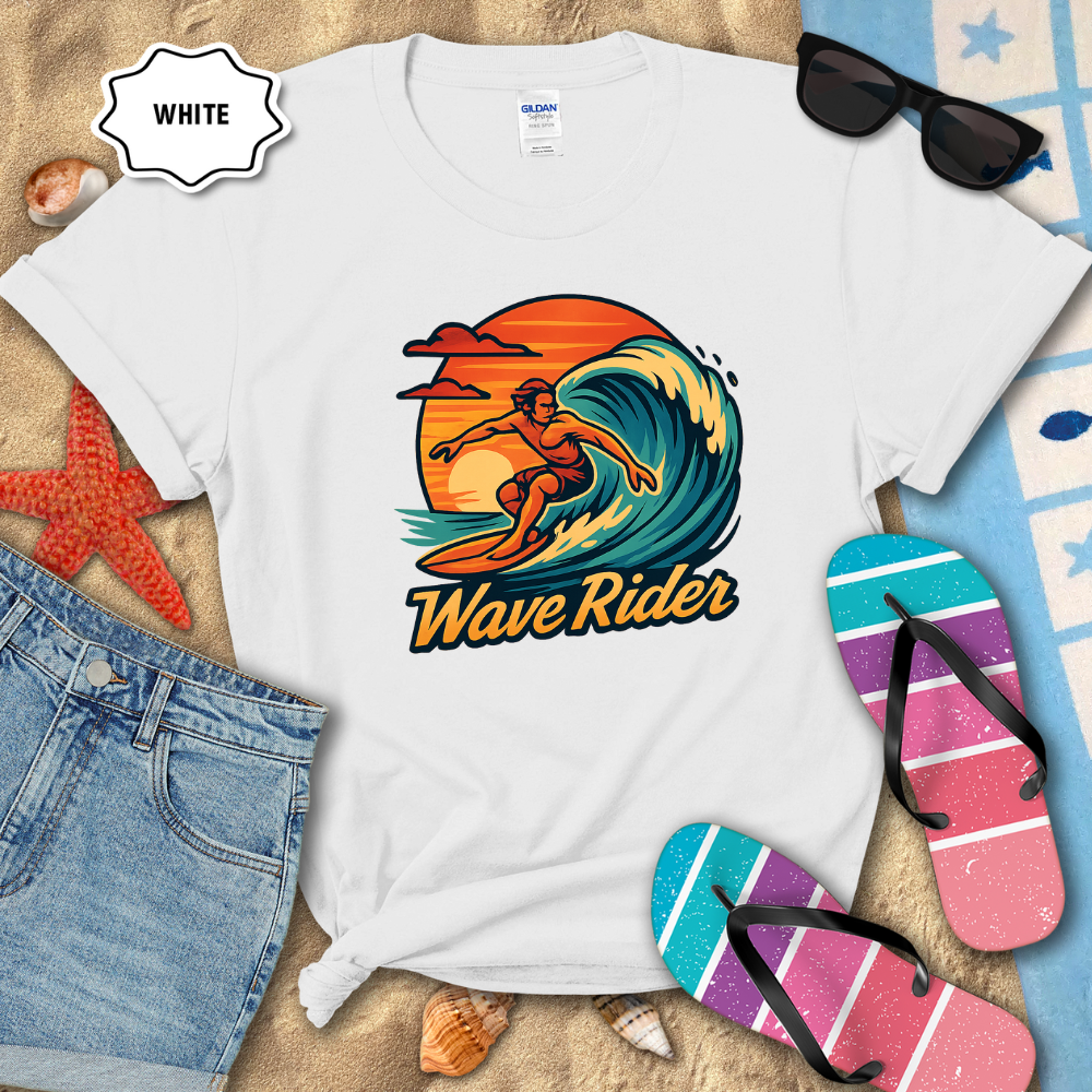 White t-shirt with 'Wave Rider' design on a sandy background with beach accessories.