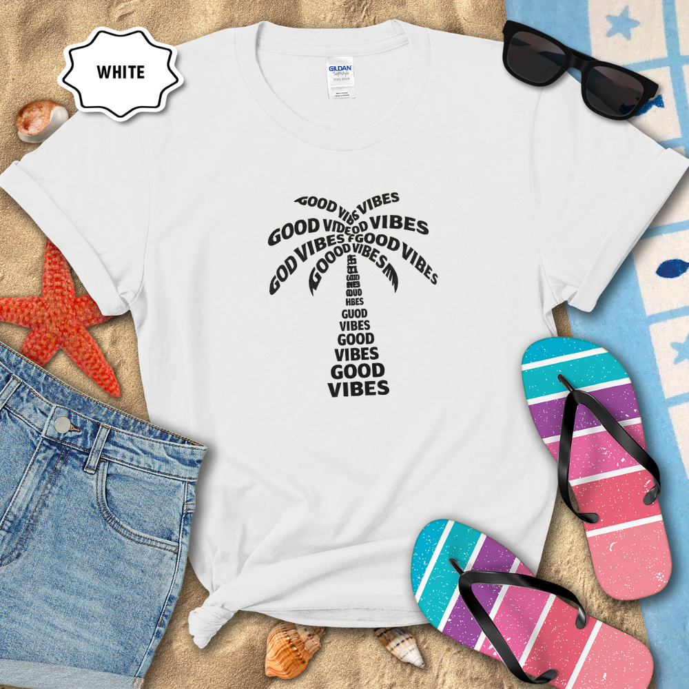 White t-shirt with 'Good Vibes' text, sunglasses, and flip-flops on a beach setting
